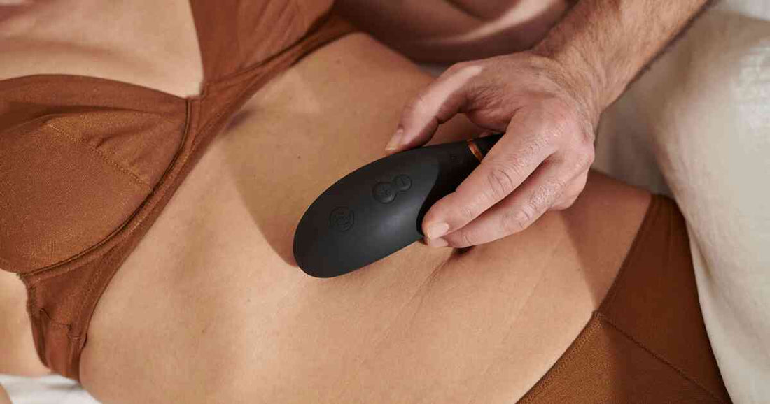 couple practicing gentle intimate wellness care with a black ergonomic massager in bed
