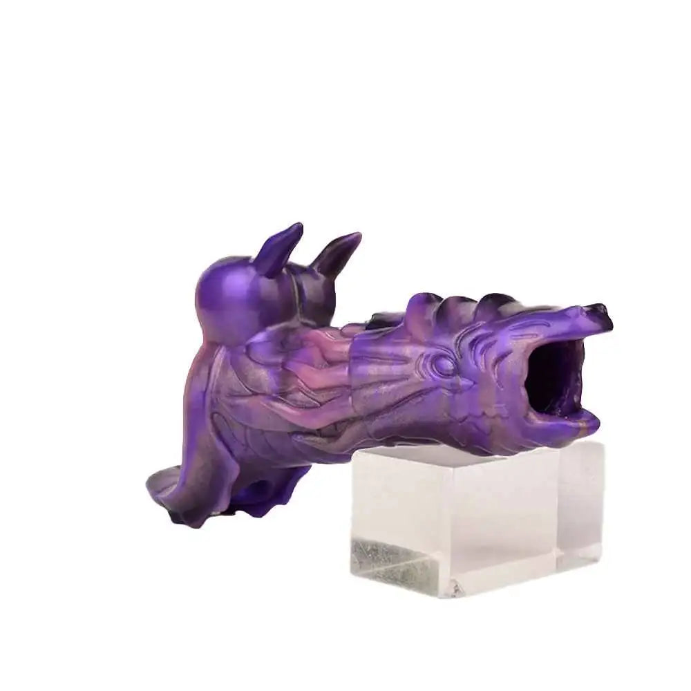 purple dragon penis sleeve resting on a clear stand showing the open jaw tip
