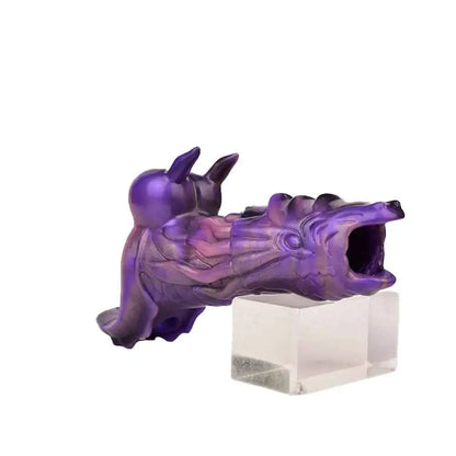purple dragon penis sleeve resting on a clear stand showing the open jaw tip